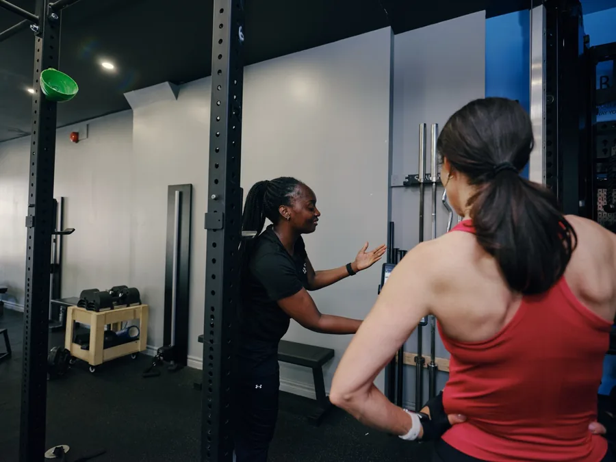 A Thrive Fit coach talking a member through their assessment