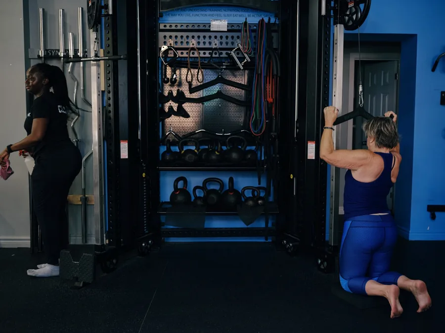 A Thrive Fit coach watching a member train