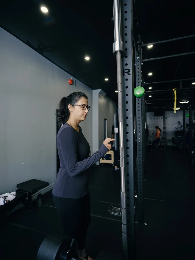 A member training alone at a rack in the Thrive Fit studio