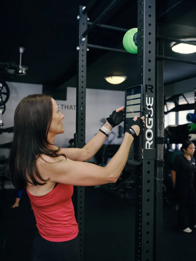 A member doing cable work at the rack at Thrive Fit