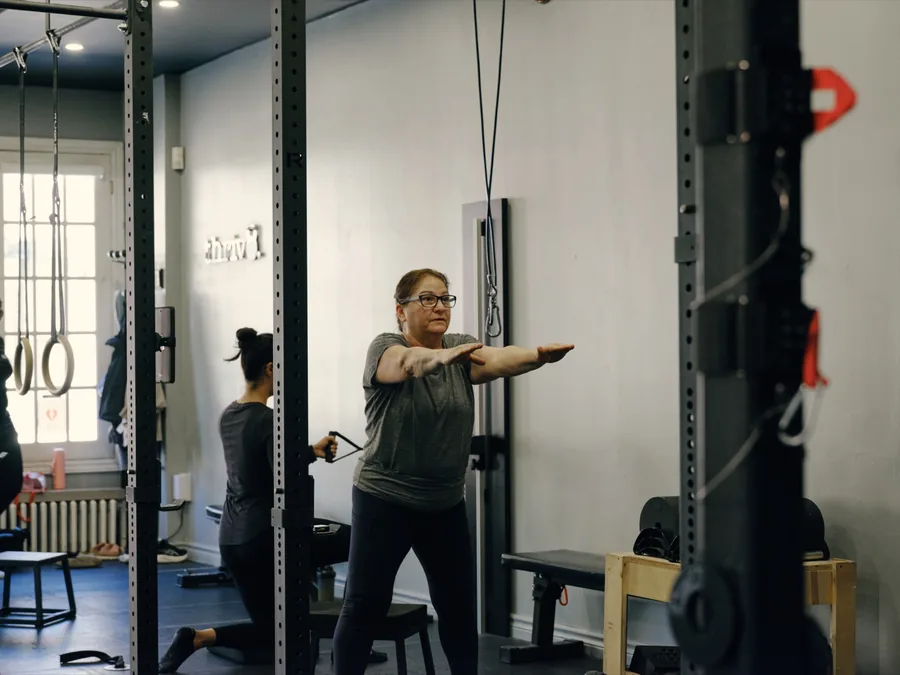 Thrive Fit: a member doing cable work on the studio floor