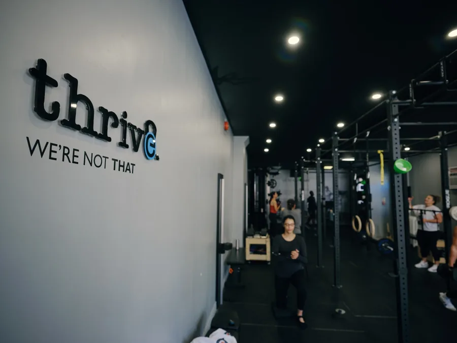 The Thrive Fit studio wall reading We are not that
