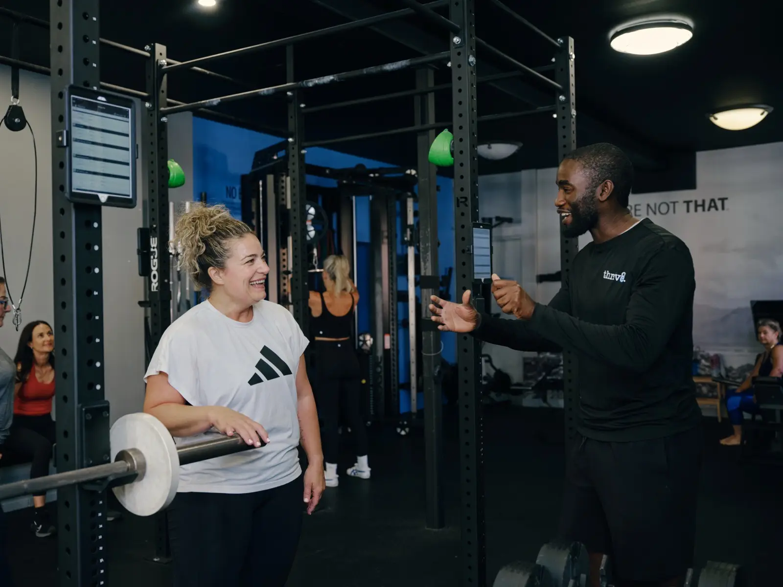 Thrive Fit: a member training on the bench with a coach nearby